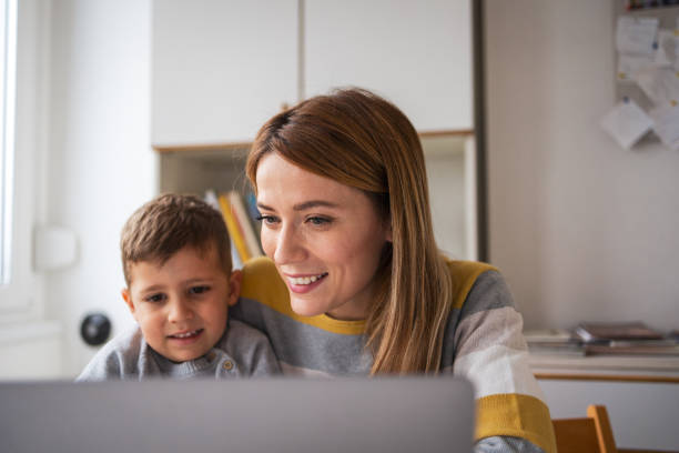 istock Happy mother and son using laptop at home office 2159523651