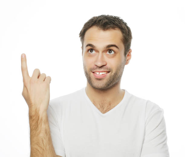 istock Young smiling happy man shows something 2159526283