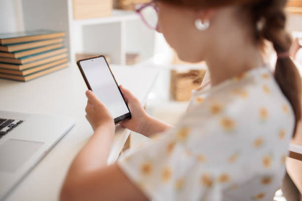 istock Girl using a smartphone at home 2159526400