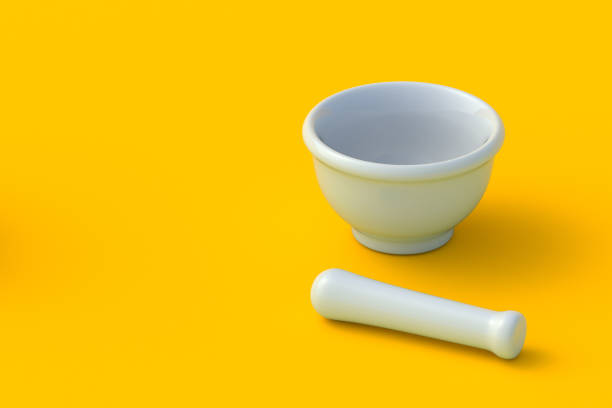 White mortar and pestle on orange background. Kitchen utensil. Pharmacy equipment. Tool for grinding ingredients. Copy space. 3d render