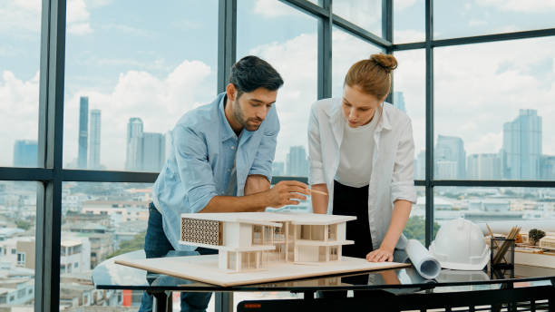 istock Cooperative engineer team working together to measure house model. Tracery 2159528182