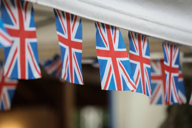 istock Multiple United Kingdom flags are blown by the wind during garden party 2159529147