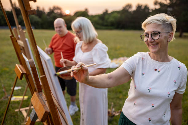 istock Friends painting outdoors in nature 2159529349