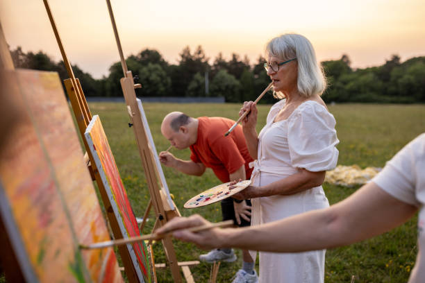 istock Friends painting outdoors in nature 2159529824