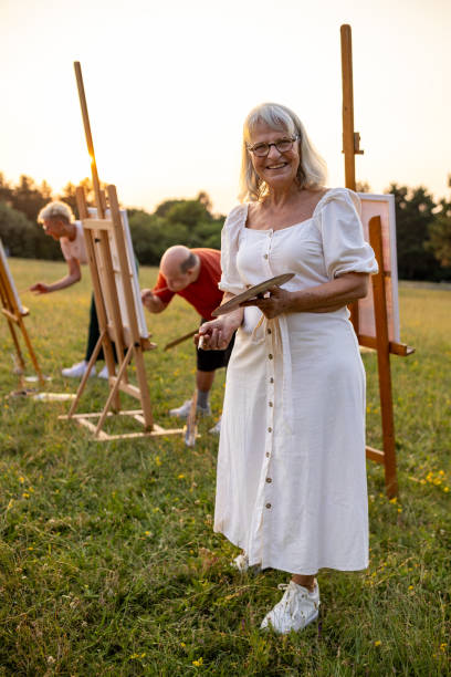 istock Senior woman painter with friends 2159530425