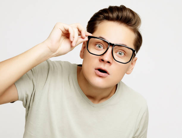 istock young man with emotions on his face a grey background 2159530676