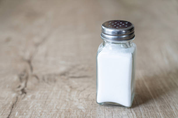 Glass salt shaker on the table. stock photo
