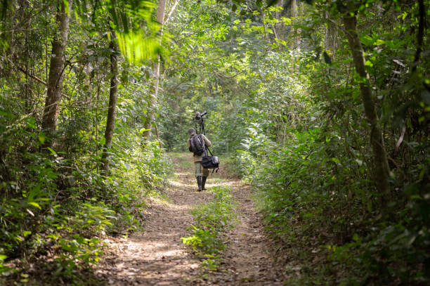 istock Man photographing and filming in the Amazon rainforest. 2159539182