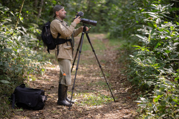 istock Man photographing and filming in the Amazon rainforest. 2159539382