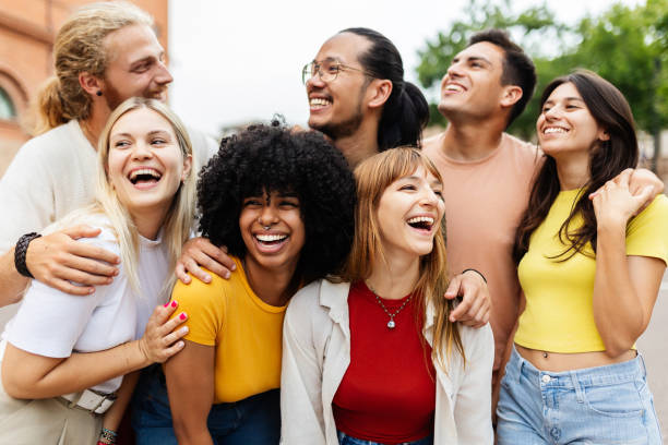 istock Diverse group of young friends having fun together outside 2159540969