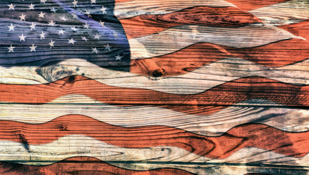istock Grunge style old American flag on wooden surface 2159542141