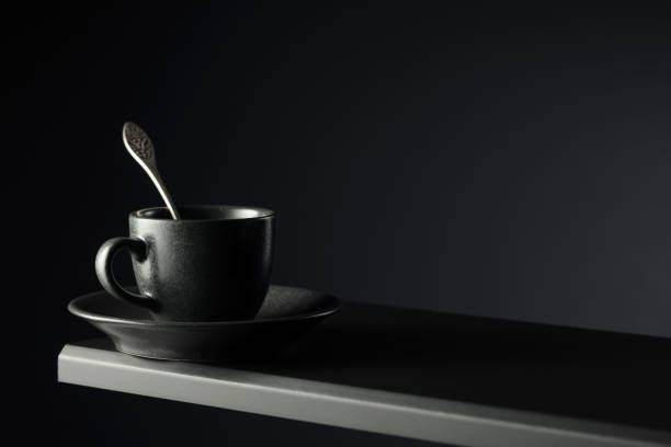 istock Black cup of coffee on a black background. 2159545737