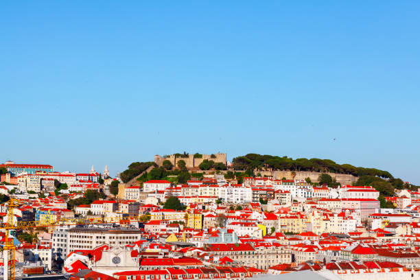 Breathtaking panorama of Lisbon, view of tiled roof houses and hilltop castle. Portugal capital city center with historic architecture