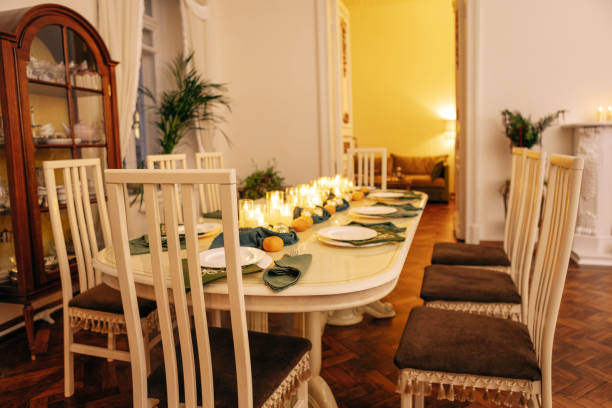 istock A dining table covered with candles and Christmas decor. Empty cutlery. Waiting for the guests. A New Year dinner or a party. 2159548626