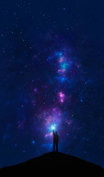 istock Space background. Man standing on hill silhouette and shine with light with colorful nebula and star field. Digital painting 2159549668