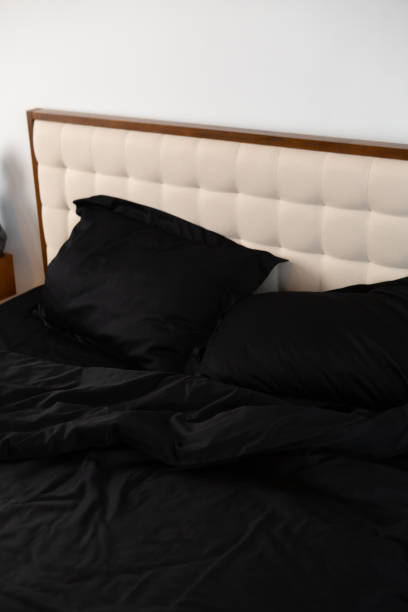 istock Morning messy on bed and black cotton textile pillows 2159550954
