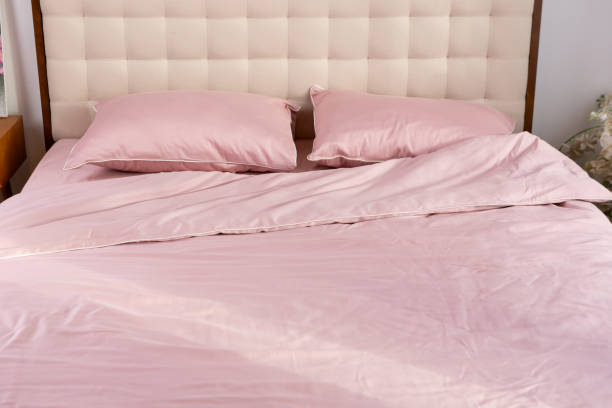 istock Morning messy on bed and pink cotton textile pillows 2159551115