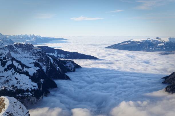 istock snow-covered mountains and dense clouds covering the valleys between them in Switzerland 2159551465