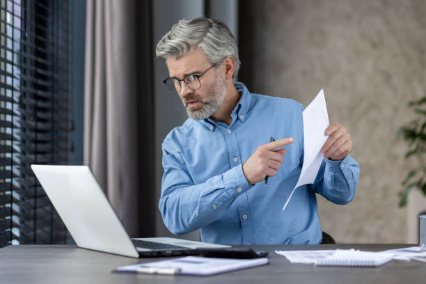 istock Businessman discussing documents during a video conference while working from home office 2159553808