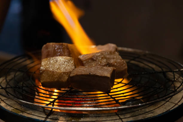 istock Chef cooking a sous vide beef tongue on fire. 2159556087