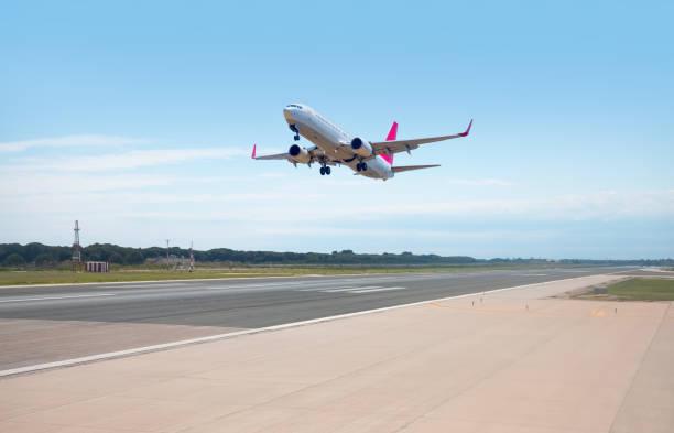 istock White Passenger plane fly up over take-off runway from airport - El Prat-Barcelona airport. This airport was inaugurated in 1963 - Barcelona, Spain 2159556830