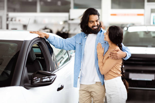 Indian Man and Woman Standing Next to Car