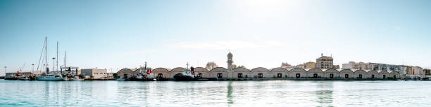 Sheds of the port. They are symmetrical and harmonious vaulted warehouses, with a beautiful Clock Tower in the center, which were built in the first third of the twentieth century.