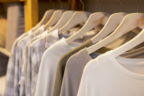 istock Clothes hanging on a hanger in a store 2159558435