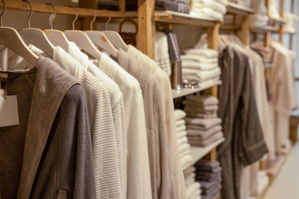 Various vibrant color shirts perfectly folded stacked on the shelf. T-shirt of different color  neatly stacked on shelves. Multicolored