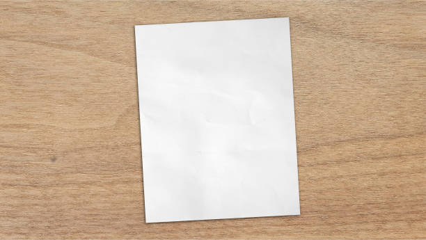 istock empty blank white grunge paper sheet placed on light oak wooden table counter, top view. sheet of blank note paper with blank space for design. 2159560483