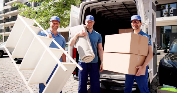 istock Professional movers working efficiently as they transport carpet and furniture 2159561905