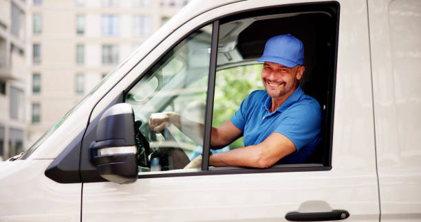 istock Efficient Courier Man in Uniform Driving Delivery Van for Reliable Service 2159561935