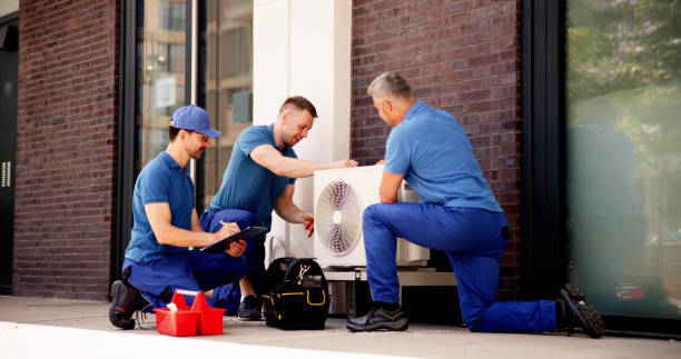 istock Skilled HVAC technician installing air conditioner unit in commercial building 2159561985