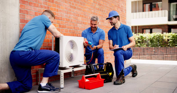 istock Skilled technician in uniform inspects commercial HVAC units 2159561989