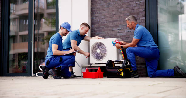istock Experienced HVAC Technician Maintaining Commercial Air Conditioner 2159562001