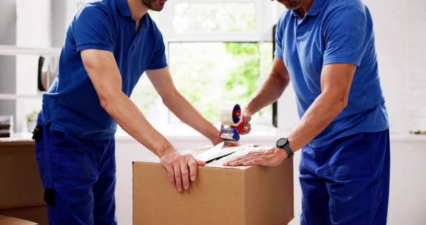 istock Group of Movers Pack Boxes for Delivery to Residential House 2159562017