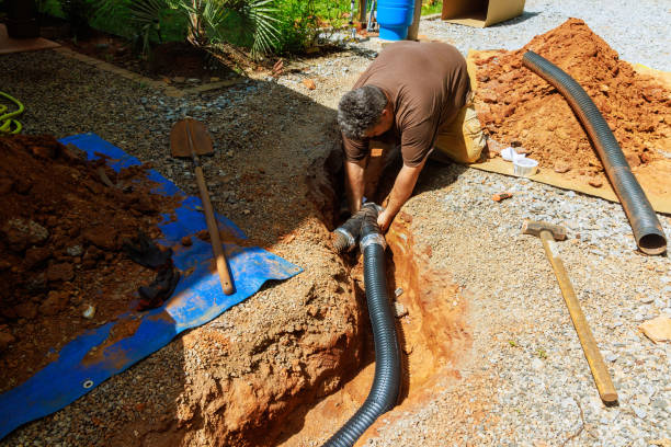 istock Assembling perforated flexible drain pipes for draining rainwater at a trench 2159562970