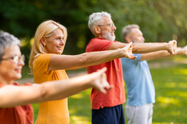 istock Group of happy seniors doing stretching exercises while training outdoors 2159563462