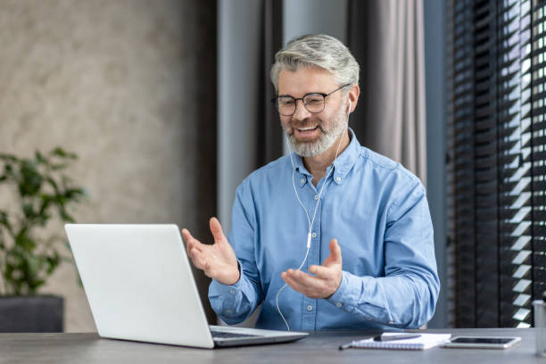 istock A senior man is happily engaging in a video call in his home office, using technology for work 2159564876