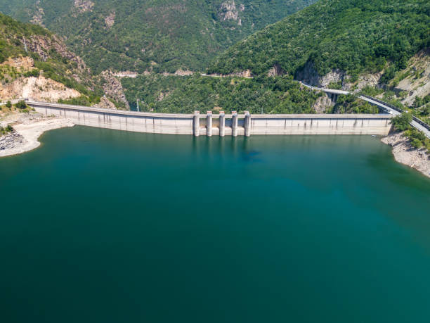 istock Hydroelectric dam generating renewable energy surrounded by lush green forest 2159565864