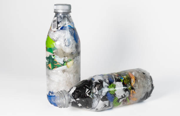 istock Ecobricks. Plastic bottles filled with waste. Environmental care and recycling concept. White background and copy space. 2159566790