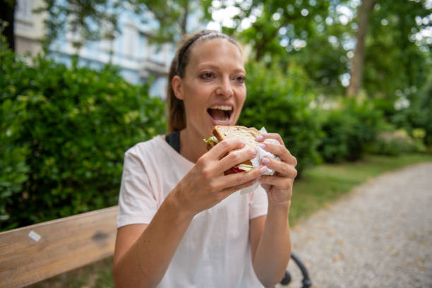 istock Eating fresh sandwich outdoors in the park 2159567235