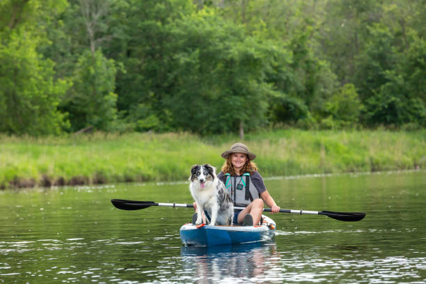 istock Girl Kayaking On River With Her Dog 2159568626