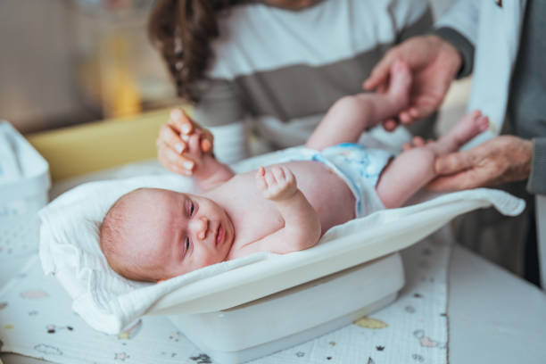 istock Senior Pediatrician Examining Infant in Hospital Setting 2159568984