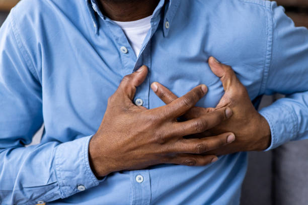 istock Man experiencing chest pain clutching his chest with both hands 2159570204