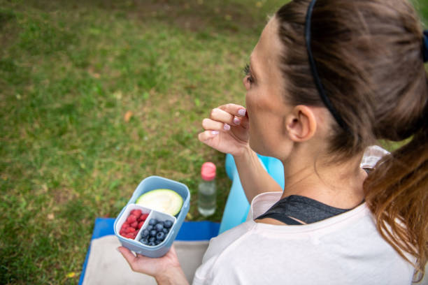 istock Eating healthy fresh berries and avocado outdoors after exercise 2159571740
