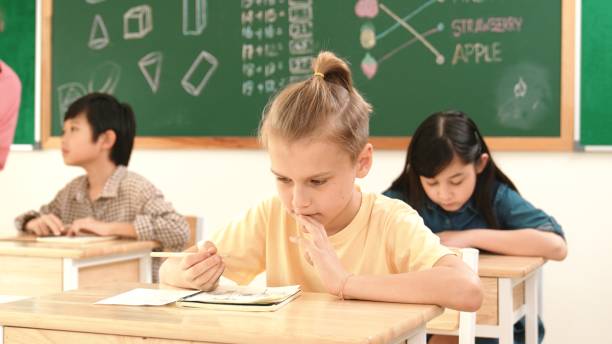 istock Stressful student focus on doing test while sitting in front of board. Pedagogy. 2159572527