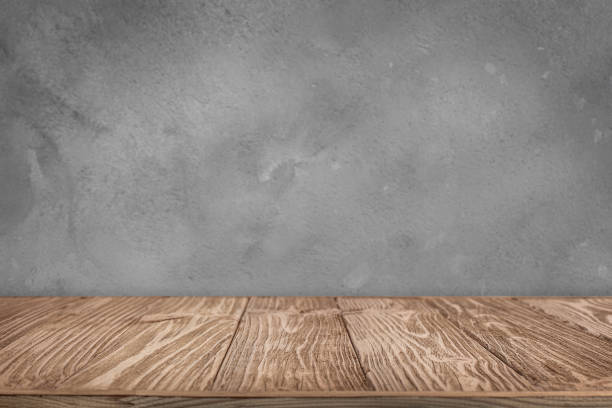 istock Wooden tabletop near cement wall as a background 2159572674