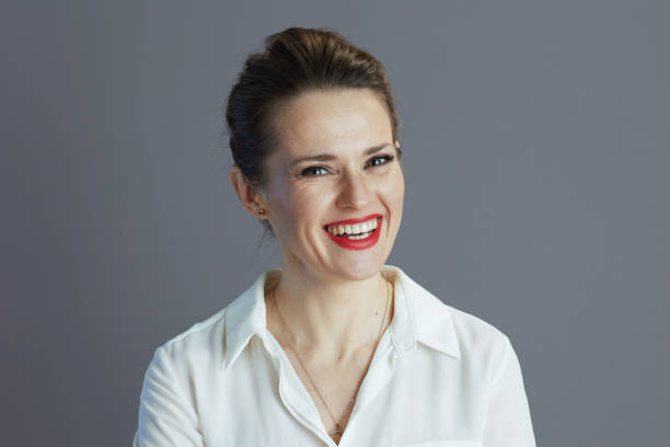 istock smiling elegant 40 years old woman worker isolated on gray 2159573551