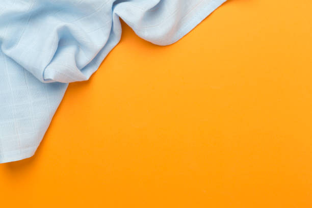 Cotton fabric on color background, top view